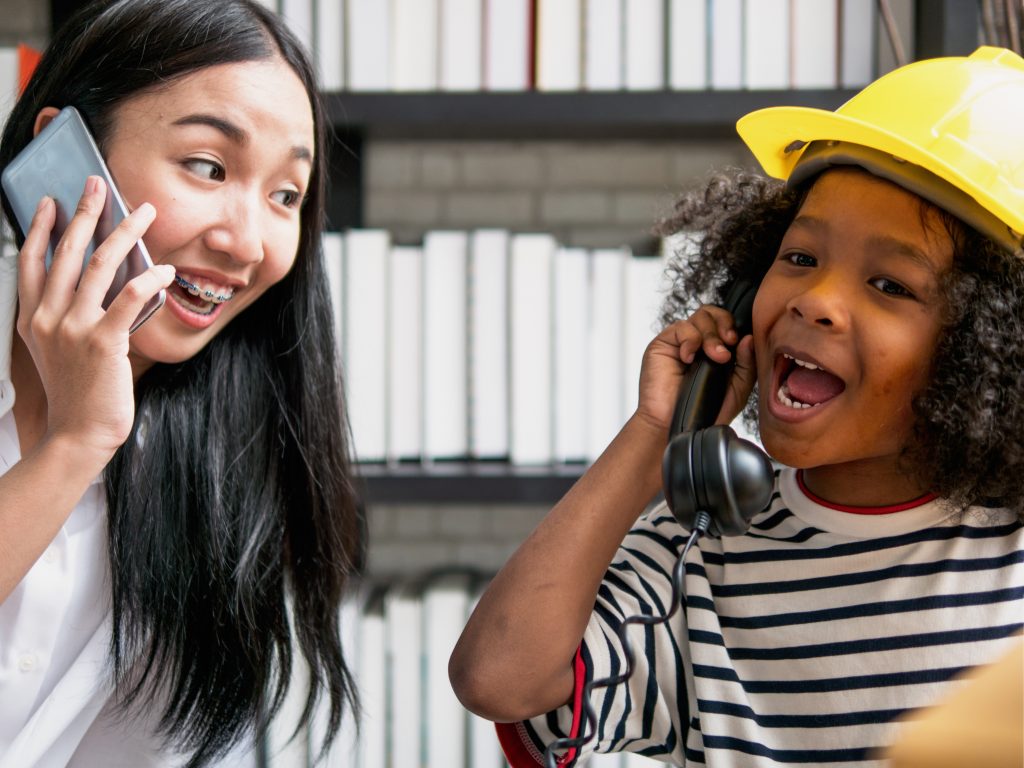 Au pair playing phone call with child